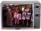 Picketers in tv frame