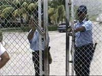 Armed guards close gate at Maquila factory to keep media out