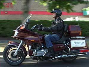 Gim Wong riding his motorcylce on the Ride for Redress