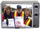 Picketers in tv frame